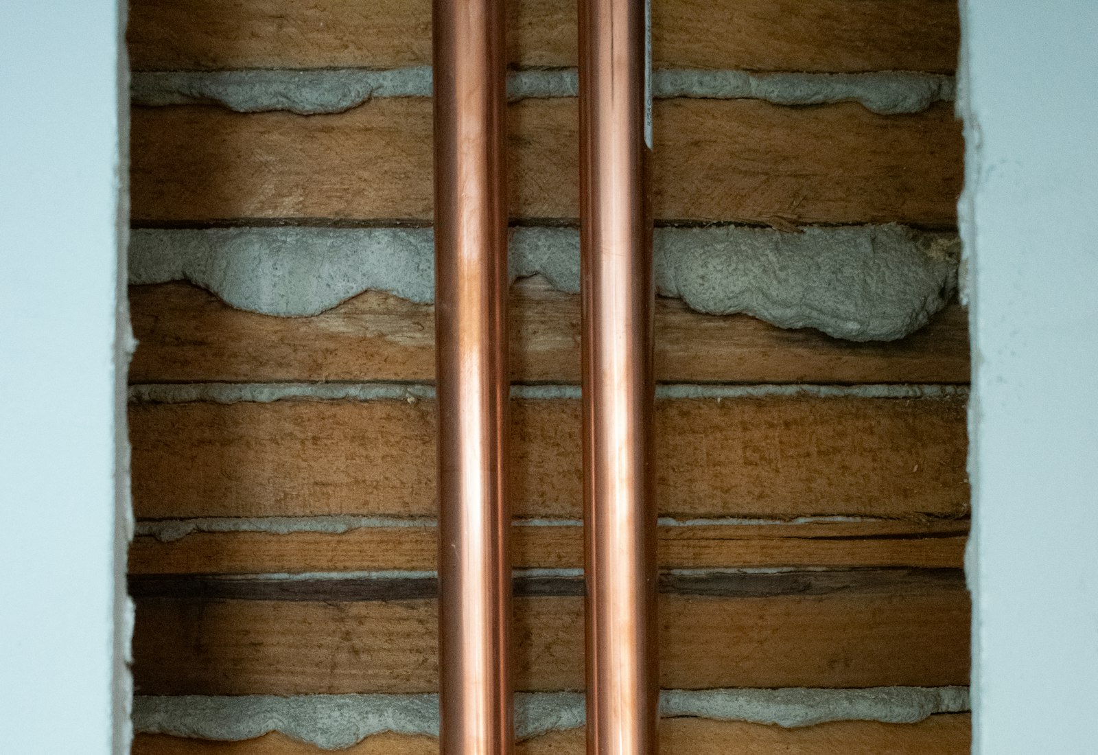 New copper pipework run neatly along a wall